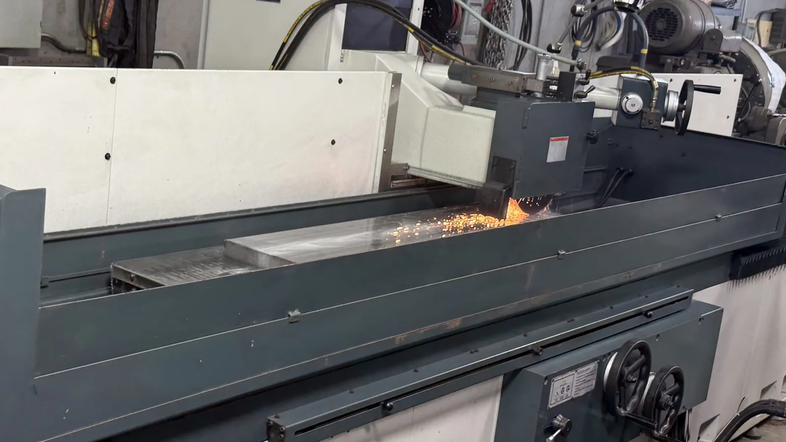 Sparks coming off a flat part being ground on the Kent KGS-620AHD at Grindmasters